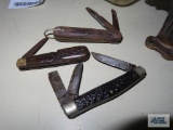 Three pocket knives. All have damage.
