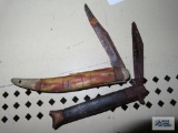 Two vintage pocket knives. Both are rusty and have damage.