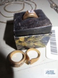 Gold colored ring with clear gemstones, marked 18 KT GE. Gold colored ring with small pear-shaped