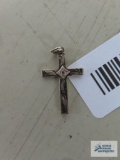 Gold colored cross etched with clear stone,marked 10K.