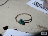 Silver colored ring with blue and black polka dot open-ended ring, marked 925.