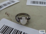 Silver colored ring with cloudy stone, marked Sterling.