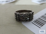 Silver colored band ring with sparkly stones, marked 925.