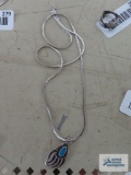Silver colored bear paw pendant with turquoise colored stone, no marking, on silver colored chain,