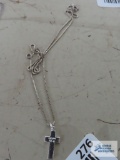 Silver colored cross pendant on silver colored chain, both marked 925.