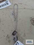 Silver colored dragon pendant, marked Sterling by Bell, on silver colored chain, marked Sterling.