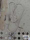 Silver colored moon pendant, marked Sterling on silver colored chain, marked 925.