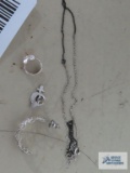 Variety of jewelry, all marked 925, including single earrings, pin, and necklace.