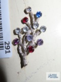 Silver colored pin with colorful gemstones, marked Van Dell Sterling.