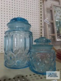 Two blue glass canisters