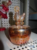 Orange carnival glass candy dish with poodle figurine lid