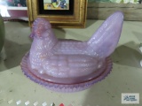 Purple glass hen on nest