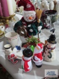 Snowman and Santa Claus figurines, serving platter, and mug