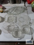 Large assortment of clear glassware including trays, celery dish, and bowls