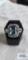 Silver colored ring with large pale blue stone and surrounding clear gemstones, marked 925, 7.5 G,