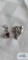 Silver colored floral pendant with clear stone, marked 925. Silver colored pendant with red stone,