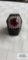 Silver colored ring with large red gemstone and surrounding clear gemstones, marked 18K HGE 10.5 G,
