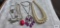 Sarah Covington purple beaded necklace and rose-colored tulip necklace. Double strand pearl like