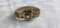 Gold colored sweetheart bracelet marked Carmen, The DFB Co.