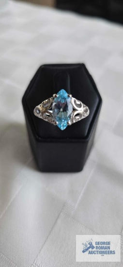 Silver colored ring with blue topaz stone, marked 925, approximately 4.2 G, size 10