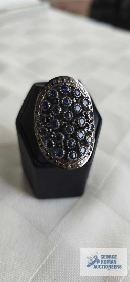 Silver colored ring with blue stones, marked 925 (marcasite), approximately 9.5 G, size 7