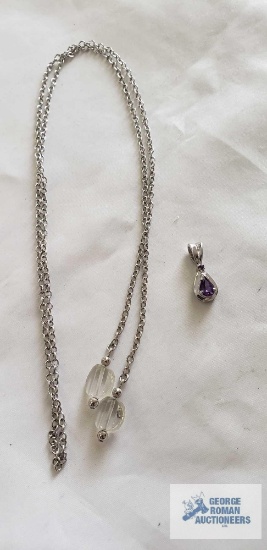Silver colored pendant with purple stone, marked 925 and open-ended silver colored chain with clear