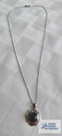 Silver colored pendant with grayish stone (Baroque Sea Pearl) on silver colored chain, both marked