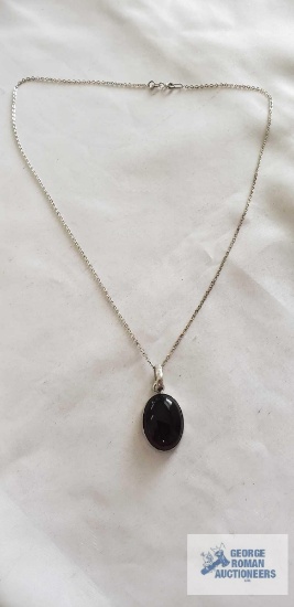 Silver colored pendant with brown stone, no marking found, on silver colored chain, marked 925