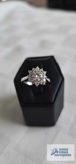 Silver colored ring with clear gemstone and surrounding clear gemstones, marked 925, 3.4 G, size 6