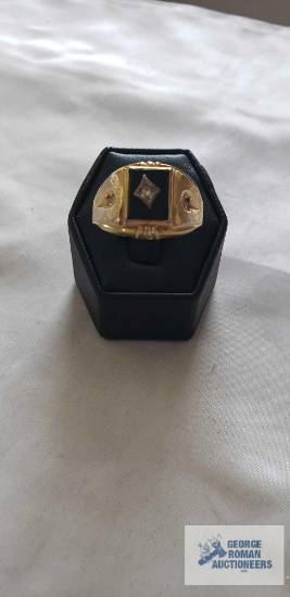 Gold colored ring with black stone and clear stone, marked 18KT HGE