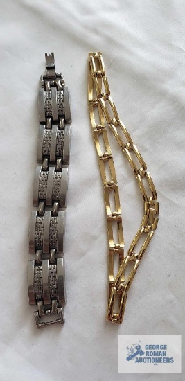 Gold colored necklace and silver colored bracelet