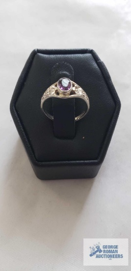 Silver colored ring with purple stone, marked 10K, 1.2 G, size 2.5
