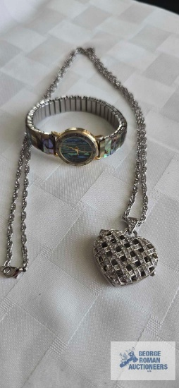 Gossip heart shaped pendant watch on silver colored chain and iridescent shell watch by Moniex.