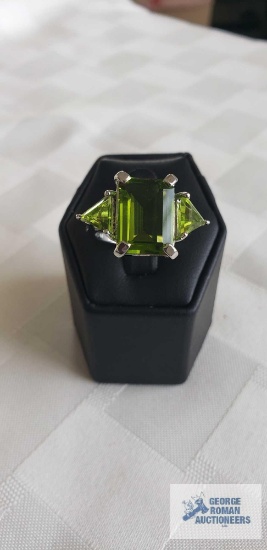Silver colored ring with large green stone and two smaller green stones, marked LNT 925, approximate