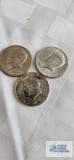 (3) 1964 Kennedy half dollars.