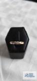 Two toned band with one single clear gemstone, marked 10K, 1.23 G, size 7