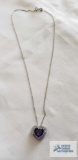Silver colored heart pendant with purple heart stone and clear gemstones, marked 925 on silver