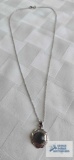 Silver colored pendant with grayish stone (Baroque Sea Pearl) on silver colored chain, both marked