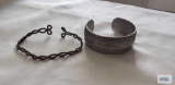 Silver colored cuff bracelet and copper colored cuff bracelet, no markings found