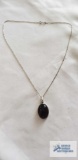 Silver colored pendant with brown stone, no marking found, on silver colored chain, marked 925