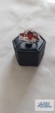 Silver colored ring with red and clear gemstones, marked 925, 4.9 G, size 8