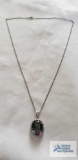 Silver colored pendant with multicolored stone on silver colored chain, both marked 925