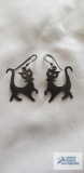 Silver colored cat dangle earrings, marked 925