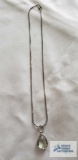 Silver colored pendant with pale green stone, no markings found, on silver colored chain, marked 925