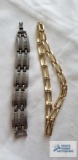 Gold colored necklace and silver colored bracelet