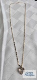 Gold colored heart pendant with clear gemstones, (diamonds) marked 14K, on gold colored twist chain,