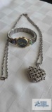 Gossip heart shaped pendant watch on silver colored chain and iridescent shell watch by Moniex.