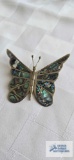 Iridescent shell butterfly pin marked HECHO EN TFX CO, approximately 4.3 G.