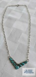 Silver colored V-shaped necklace with turquoise colored stones, marked 925, approximately 6.2 G