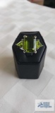 Silver colored ring with large green stone and two smaller green stones, marked LNT 925, approximate